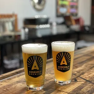 two glasses of beer on a bar