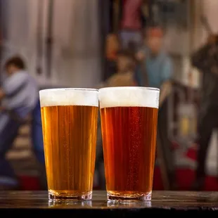 two glasses of beer on a table
