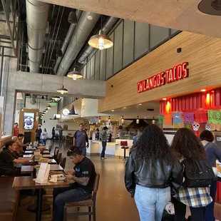 people sitting at tables and eating