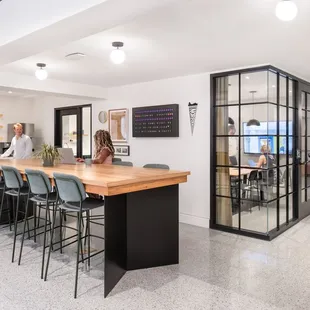Our shared kitchen, dining area, and one of our meeting rooms. The dining table top is from the original boardroom of the building.
