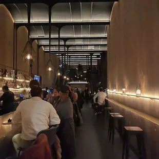 people sitting at a bar in a restaurant