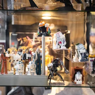 R2D2s. Lego Figures. Star Ships. Action Figures. 

Get your fix at Assorted Table Wine &amp; Shop!