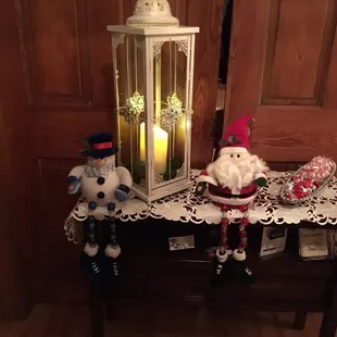 two christmas figurines on a table
