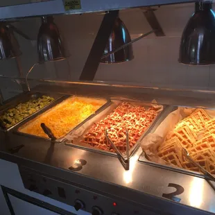 a variety of food in a buffet