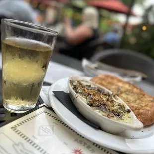 a plate of food and a glass of beer