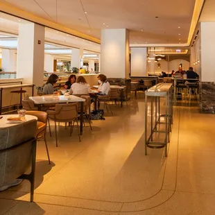 people sitting at tables in a restaurant