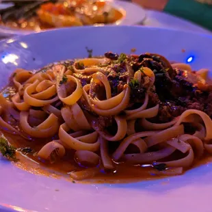 a plate of pasta with meat and vegetables