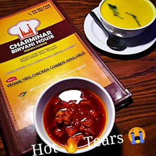  bowl of soup and a menu