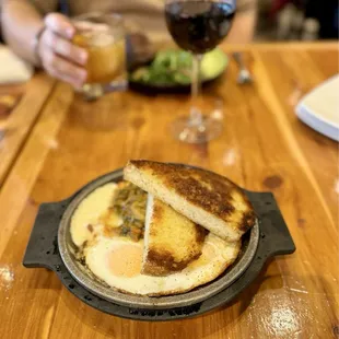 a plate of food and a glass of wine