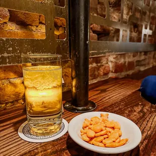 a plate of crackers and a glass of beer