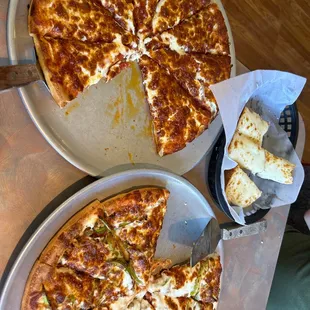 two pans of pizza on a table