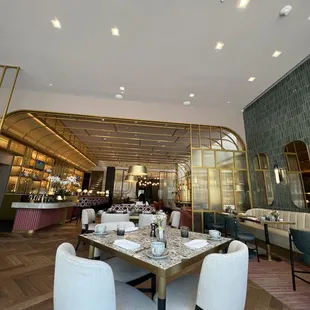 a dining area with a table and chairs