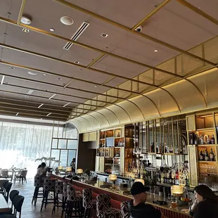people sitting at a bar in a restaurant