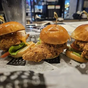 three chicken sandwiches with lettuce and tomato