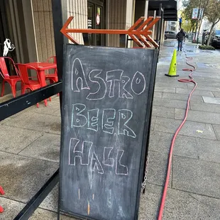 a chalkboard sign on the sidewalk