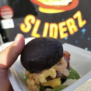 a hand holding a sandwich