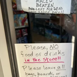 Signage about solicitors, food, drinks, and bags posted outside.