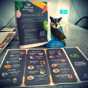 a menu and a bird figurine