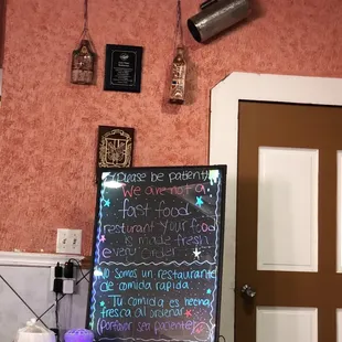 More art and a notice saying not to be in a rush because the food comes out fresh to order