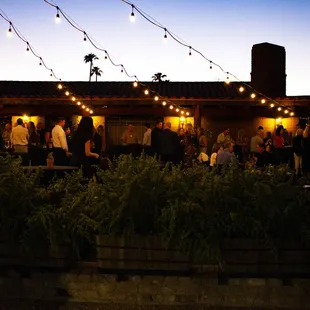 a large group of people gathered outside a restaurant