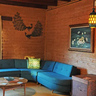 a living room with a blue couch and a coffee table