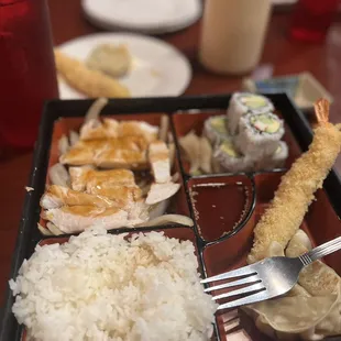 Chicken teriyaki, rice, sushi, yum yum sauce, sweet n sour sauce, and I can&apos;t remember what the other food item