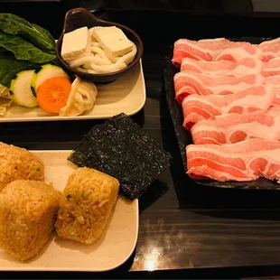 Premium pork belly with vegetables, gyoza, udon noodles and three musubi