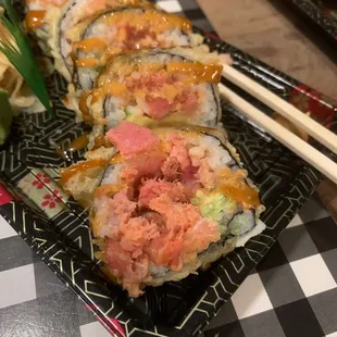 a plate of sushi and chopsticks