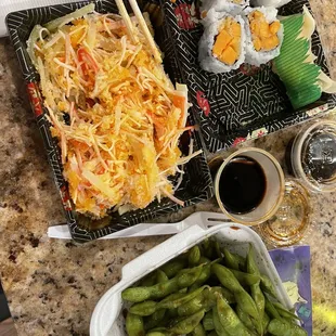 a variety of sushi and vegetables on a table