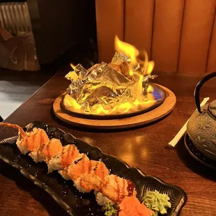 Spider roll ( front) and volcano roll( flaming in back)