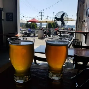 two glasses of beer on a table