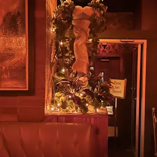 a christmas tree in a corner of a restaurant