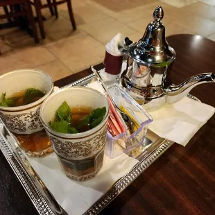 two cups of soup and a teapot