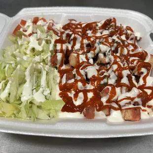 ketchup and lettuce in a styrofoam container
