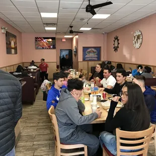 a group of people eating at a restaurant