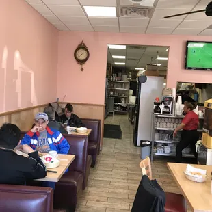 people sitting at tables in a restaurant