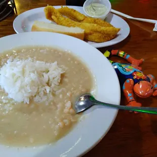 a bowl of soup with rice and bread