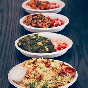 three bowls of food on a table