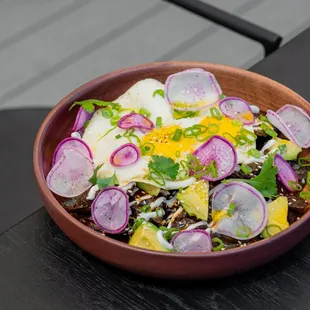 Blue Corn Chilaquiles. Molé negro. Sunnyside Egg. Avocado. Yogurt Crema. Sesame. Scallion. (Photo: Kimberly Motos)