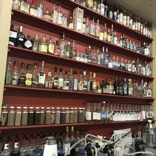 a shelf full of liquor bottles