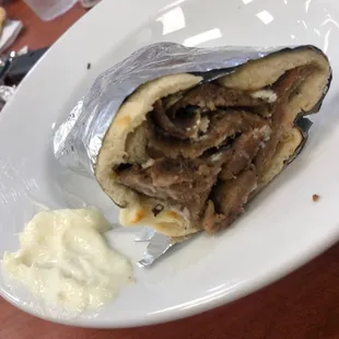 Customized gyro wrap w tahini, feta, and a side of garlic sauce. SO YUMMY