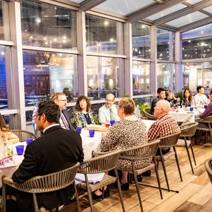 a large group of people sitting at tables