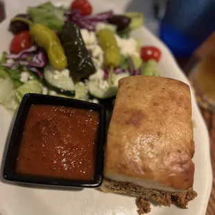 a plate of food with a salad and a sandwich