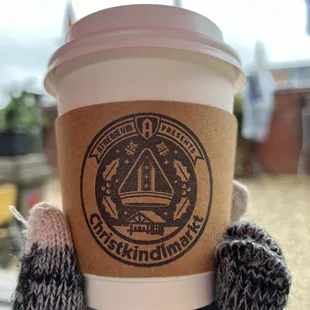 a person holding a cup of coffee