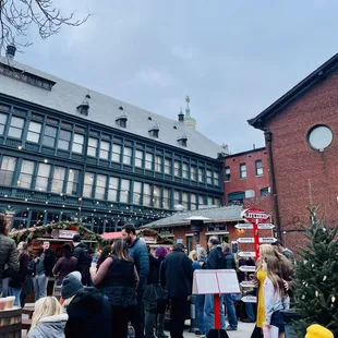 a large group of people standing in front of a building