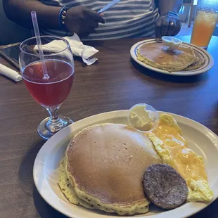 Strawberry cranberry mimosa, pancakes, eggs, and sausage.