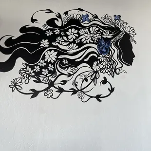 a woman&apos;s profile with flowers in her hair