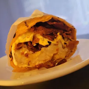 a breakfast burrito on a plate