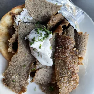 a plate of meat and bread