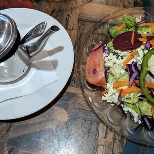 a plate of salad and a cup of coffee